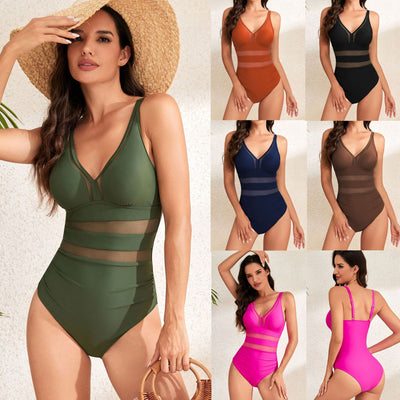 Woman wearing a black one-piece swimsuit with mesh panels and a V-neckline, posing against a white wall. - Image 7