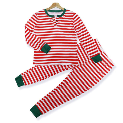 Family of four wearing matching red and white striped Christmas pajamas with green cuffs. One child wears a Santa hat, another wears reindeer antlers. - Image 18