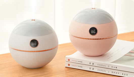 Pink spherical humidifier with a white top, ribbed texture, rose gold band, and a digital display showing 73%. - Image 9
