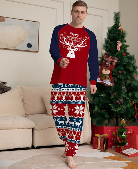 Child wearing a red and navy blue Christmas pajama set with a white reindeer and "happy NEW YEAR" text on the top, and fair isle pattern pants. - Image 5