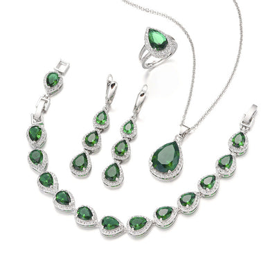 Green pear-shaped gemstone jewelry set with necklace, dangle earrings, ring, and bracelet, all with clear stone accents. - Image 7