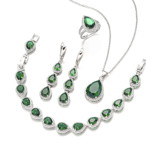 Green pear-shaped gemstone jewelry set with necklace, dangle earrings, ring, and bracelet, all with clear stone accents. - Image 7