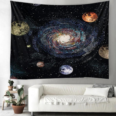 Printed solar system tapestry with a vibrant galaxy and planets design, hanging on a wall above a white sofa.