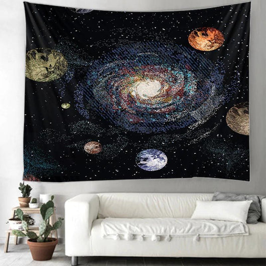 Printed solar system tapestry with a vibrant galaxy and planets design, hanging on a wall above a white sofa.