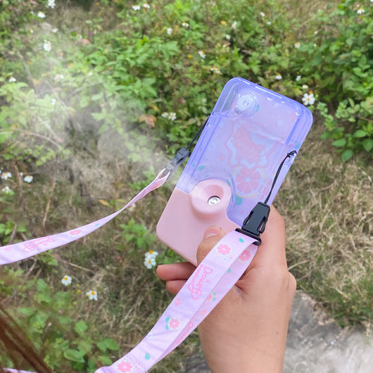 Pink and clear portable handheld humidifier with a fruit pattern, mist nozzle, and a matching pink neck lanyard. - Image 6