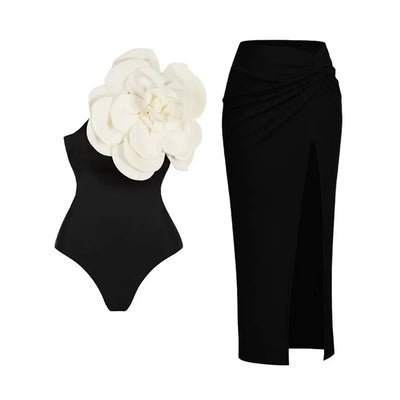 Black one-piece swimsuit with a large 3D flower on one shoulder and a geometric pattern on the bodice. - Image 7