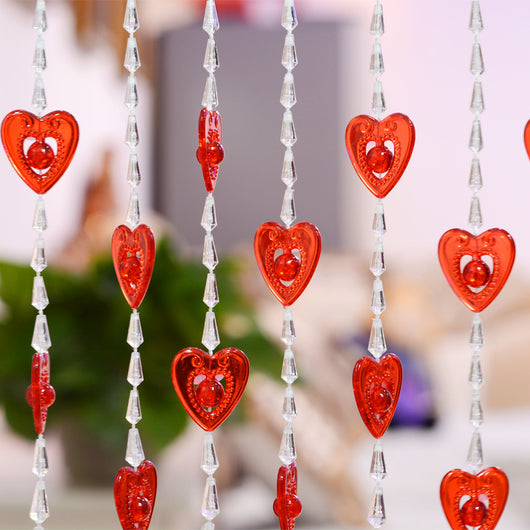 Close-up of a decorative door curtain with alternating red heart-shaped beads and clear faceted acrylic beads. - Image 15