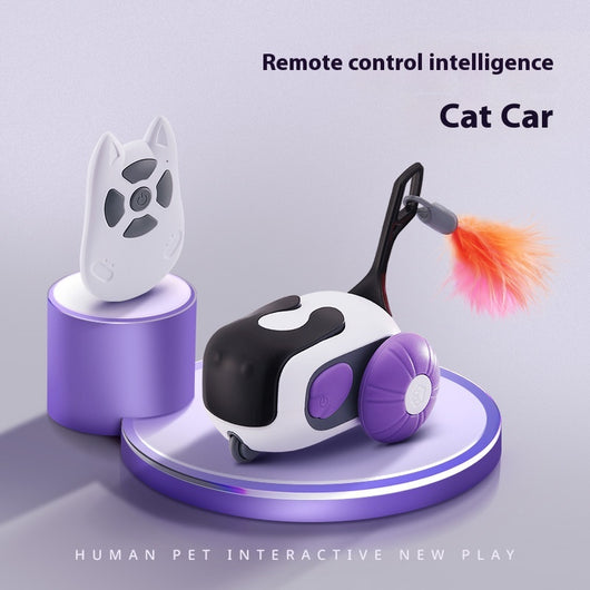 White and black remote control cat toy car with purple wheels and an orange feather, next to a white cat-shaped remote. - Image 6