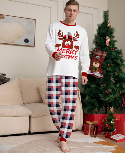 Young girl in a white long-sleeve Christmas pajama top with a reindeer graphic and red plaid pajama pants. - Image 8