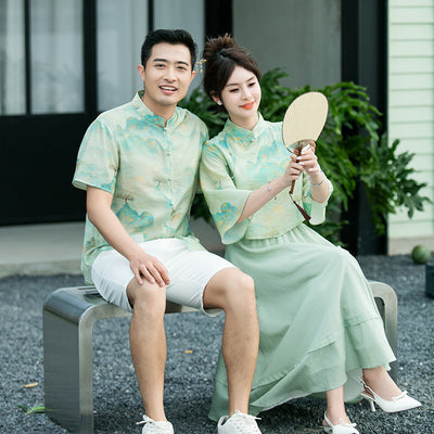 Mother and daughter in matching light green Chinese style cheongsam suits with patterned tops and solid skirts. - Image 3