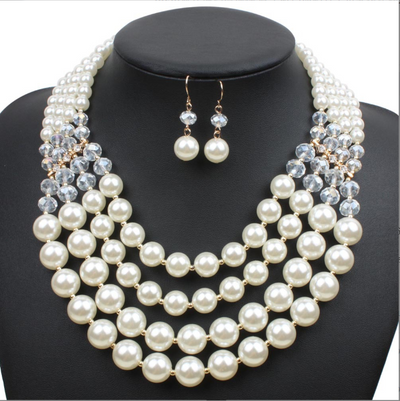 Multi-strand faux pearl and crystal necklace with matching drop earrings on a black jewelry bust. - Image 5