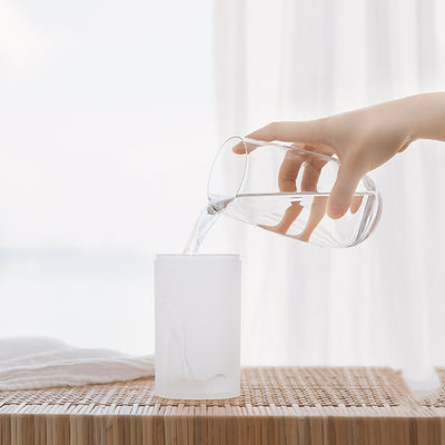 White and clear cylindrical car air humidifier with a gold top accent, designed for in-car air hydration. - Image 3