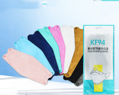 A fan of multi-colored KF94 fish-shaped masks in pink, blue, teal, white, gold, black, and grey, next to a packaged mask. - Image 30