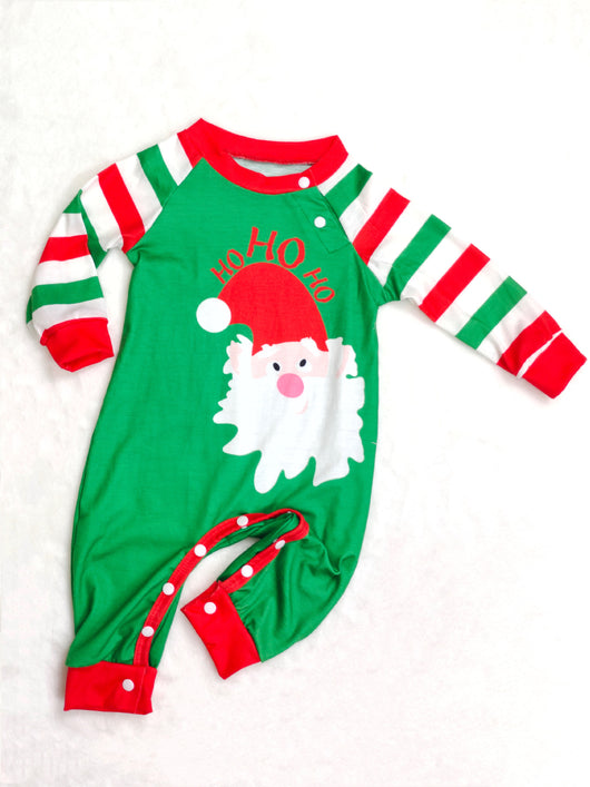 Woman wearing a green, red, and white striped Christmas pajama set with a Santa Claus graphic on the top. - Image 12
