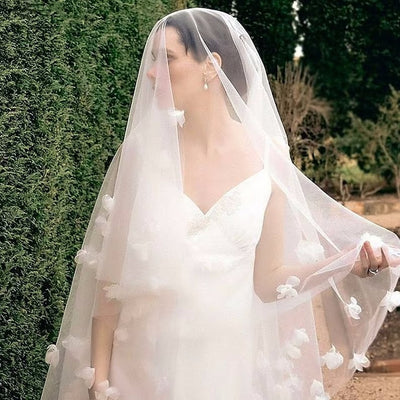 White and ivory sheer fabric swatches for a wedding veil displayed on green grass. - Image 7