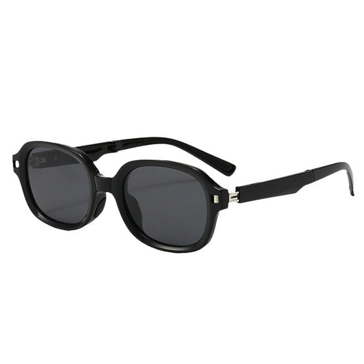 Brown oval sunglasses with dark lenses and thick frames, featuring visible silver hinges on a light gray background. - Image 5
