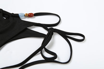 Women's fashionable three-piece bikini set with an abstract orange, brown, and blue print. Features a triangle top, mesh mini skirt, and lace-up details with be - Image 10