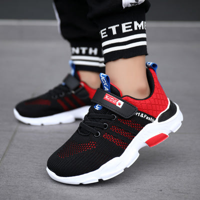 Boy's black and blue sports shoes with orange accents, mesh upper, white sole, blue laces, and a Velcro strap. - Image 4