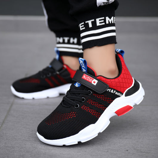 Boy's black and blue sports shoes with orange accents, mesh upper, white sole, blue laces, and a Velcro strap. - Image 4