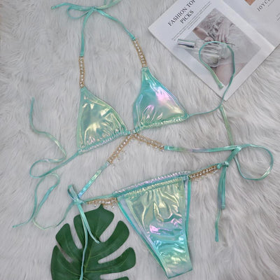 Iridescent purple and pink two-piece bikini with gold-toned crystal embellishments on a white faux fur background. - Image 38