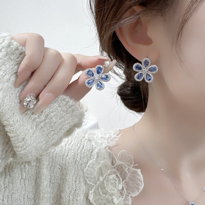 Elegant jewelry set with a silver-tone necklace and matching stud earrings, featuring blue and clear floral gemstones. - Image 13
