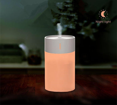 Cylindrical humidifier with a frosted white body and a light pink top, featuring a small mist outlet. - Image 14