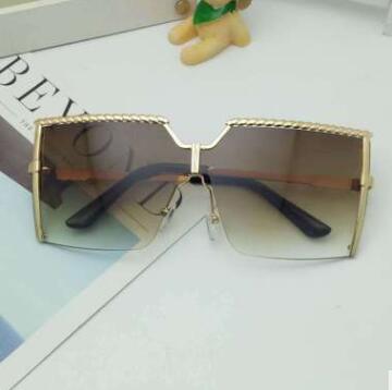 Frameless conjoined sunglasses with gold metal frame and braided detail, featuring brown gradient lenses. - Image 8