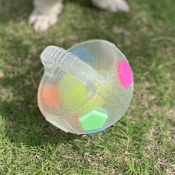 Black and white soccer ball dog toy with a textured handle, designed for interactive play and self-amusement.