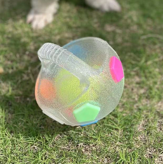 Black and white soccer ball dog toy with a textured handle, designed for interactive play and self-amusement.