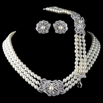 Three-strand pearl necklace with a rhinestone flower clasp and matching pearl and rhinestone flower stud earrings. - Image 7