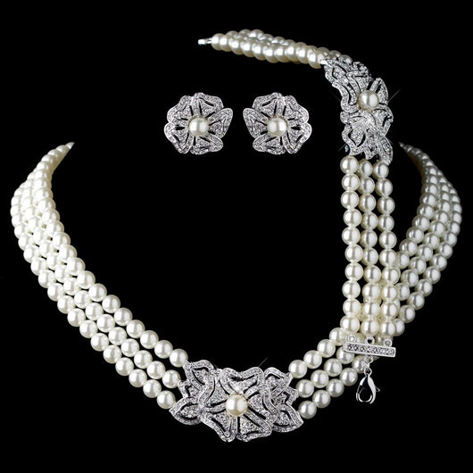 Three-strand pearl necklace with a rhinestone flower clasp and matching pearl and rhinestone flower stud earrings. - Image 7