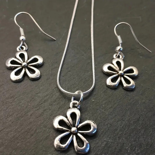 Silver-colored snake chain necklace with a delicate flower pendant and an adjustable lobster clasp closure.