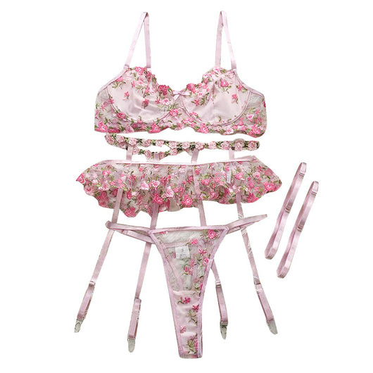 Pink floral embroidered lace lingerie set with bra, garter belt, and thong on a white textured background. - Image 5