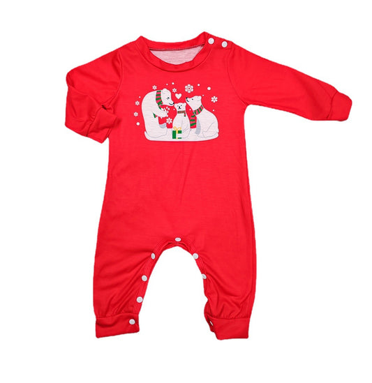 Family of four wearing matching red Christmas pajamas with polar bear and snowflake print, standing by a Christmas tree. - Image 2