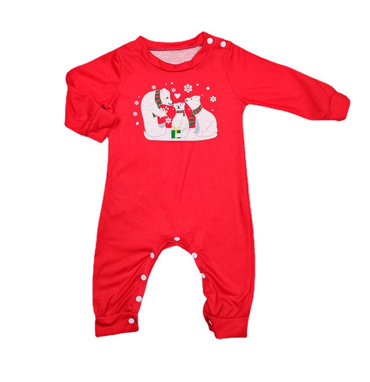 Family of four wearing matching red Christmas pajamas with polar bear and snowflake print, standing by a Christmas tree. - Image 2