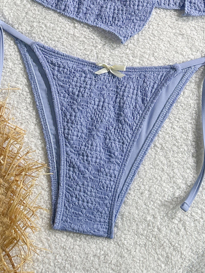 Light blue textured two-piece bikini with a strapless top and high-cut bottom with side ties and white bows. - Image 13