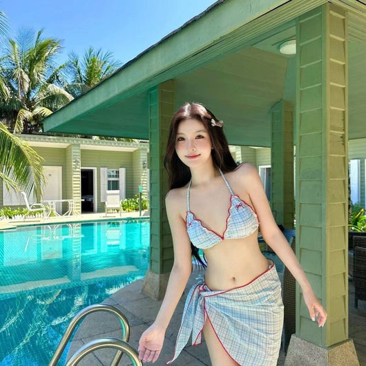 Woman in a retro plaid bikini three-piece set with a halter top, bikini bottom, and matching sarong skirt. - Image 17