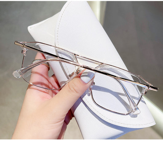 Anti-blue light glasses with a sand black and silver double beam frame, held against a white case. - Image 25