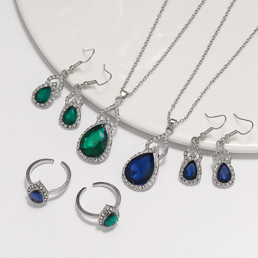 Light luxury jewelry set with silver-tone necklace, dangle earrings, open ring, and bracelet, all featuring emerald green teardrop and oval stones with clear rh - Image 3