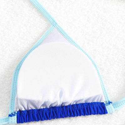 Royal blue two-piece bikini with light blue trim and tie straps, laid flat on a white textured surface. - Image 25