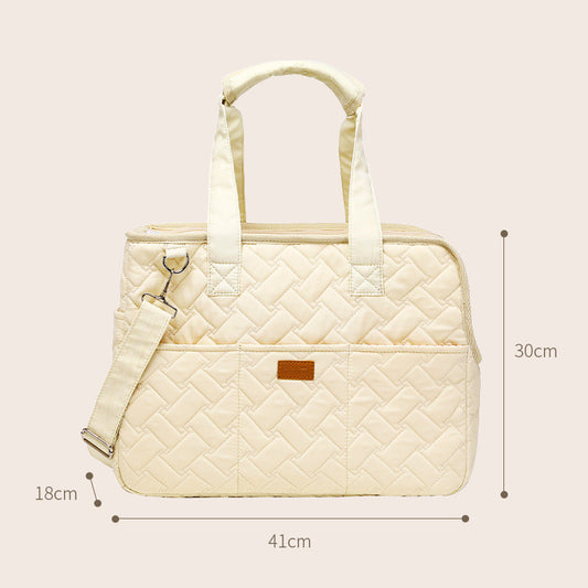 Cream quilted portable pet carrier with top handles, detachable shoulder strap, front pocket, and ventilation mesh. - Image 2