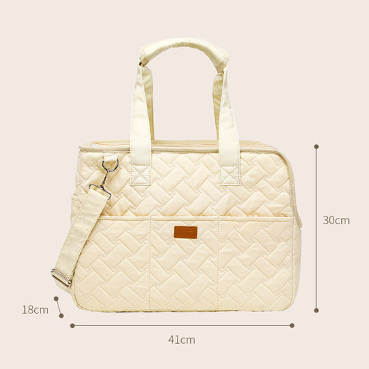 Cream quilted portable pet carrier with top handles, detachable shoulder strap, front pocket, and ventilation mesh. - Image 2