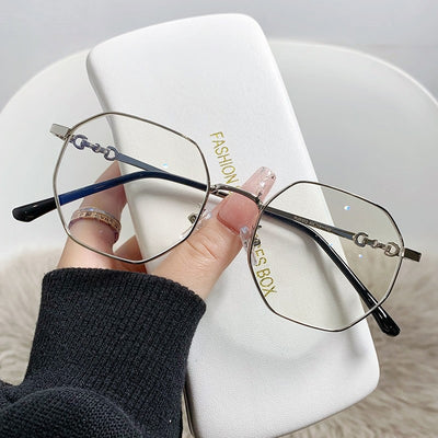 Rose gold frameless polygon anti-blue light glasses with clear lenses, held by a hand with pink nails. - Image 15