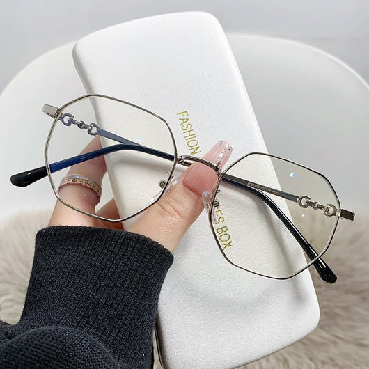 Rose gold frameless polygon anti-blue light glasses with clear lenses, held by a hand with pink nails. - Image 15