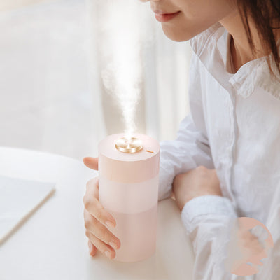 White and clear cylindrical car air humidifier with a gold top accent, designed for in-car air hydration.