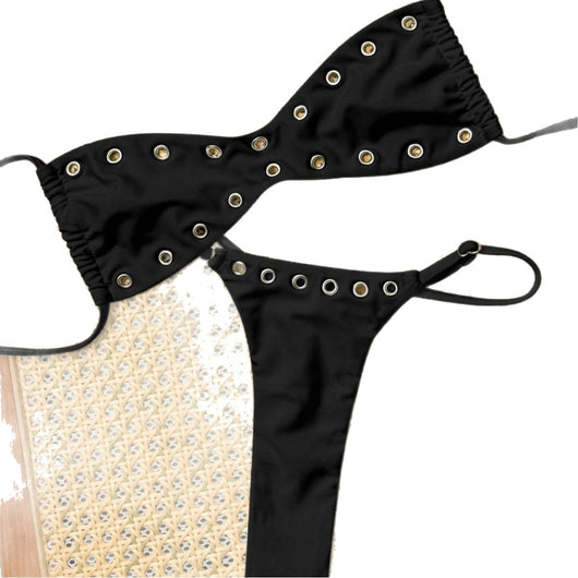 Black bandeau bikini swimsuit with thin straps and a gold-toned abstract ring detail on the top, paired with matching string bottoms. - Image 5