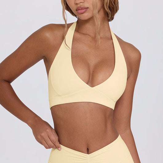 Light pink halter neck sports bra and high-waisted leggings workout set on a model. - Image 8
