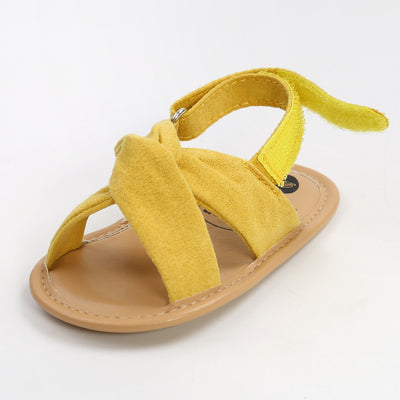 Black baby sandals with knotted cross straps and a matching black floral headband on a white background. - Image 36