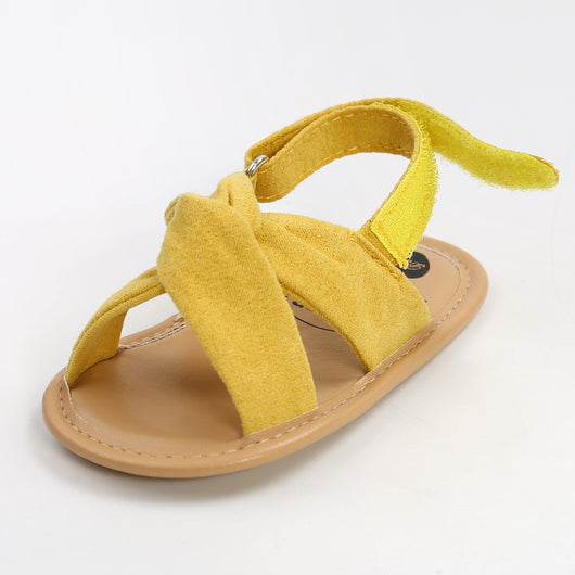 Black baby sandals with knotted cross straps and a matching black floral headband on a white background. - Image 36