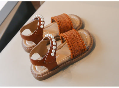 Children's white sandals with pearl ankle straps, woven front strap, and brown sole, featuring a Velcro closure. - Image 16